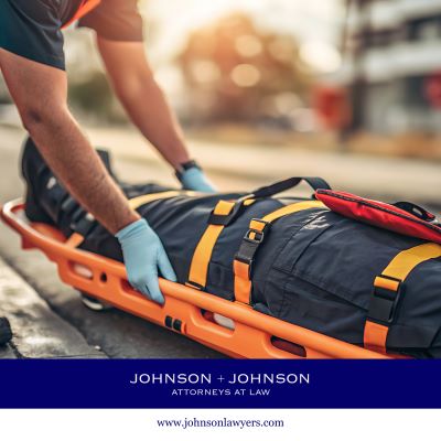 Emergency responders carrying an injured person on a stretcher.