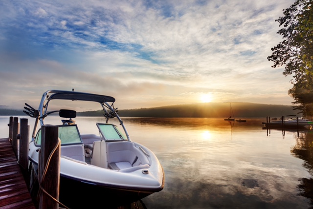 Boat on lake at sunset