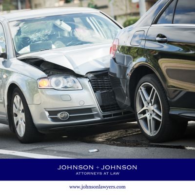 A silver car rear-ending a black car at a West Columbia intersection