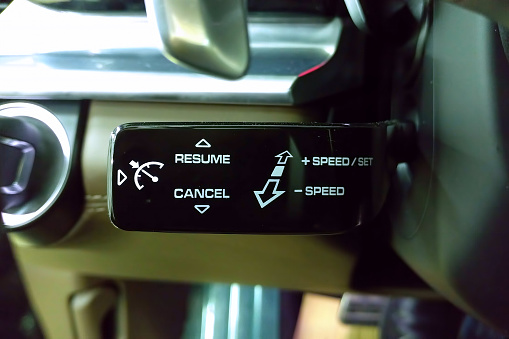 Cruise control switch under the steering wheel of car