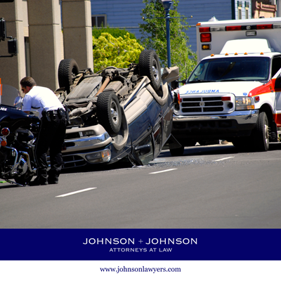 The scene of a rollover car accident in Denton, SC with an ambulance waiting to take injury victims for treatment