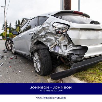 A silver car with significant rear-end damage after a Forest Acres car accident
