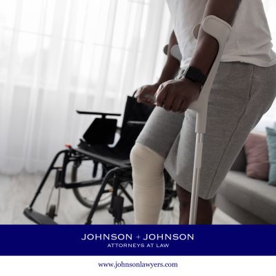 Person with a leg injury using crutches standing beside a wheelchair, representing personal injury recovery and legal assistance.