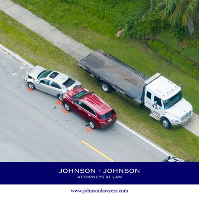 Aerial view of a tow truck about to carry two cars away from the scene of a car accident in Forest Acres, SC