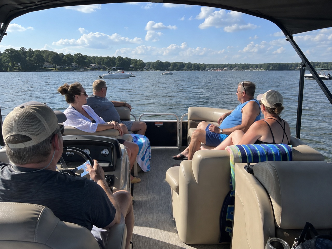 A group of passengers relaxing aboard a pontoon boat on Lake Murray in South Carolina, illustrating a recreational boating outing relevant to passenger injury and boat operator liability claims.