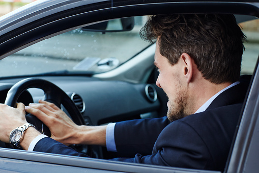 Aggressive driver in car, side view