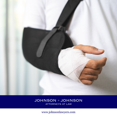 Close-up of a person with a bandaged hand wearing a arm sling after an accident in St. Andrews caused by negligence.